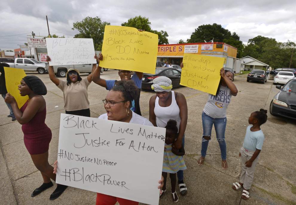 Dozens of protesters in Louisiana on Tuesday chanted slogans and held up signs demanding justice for a black man fatally shot in an altercation with two police officers hours earlier, video postings on social media showed.
