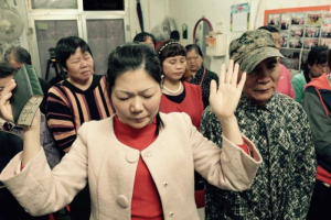 PHOTO: People pray at a small Protestant underground church that operates in a shopfront in Beijing <br />
 <br/>Wayne Mcallister, ABC News