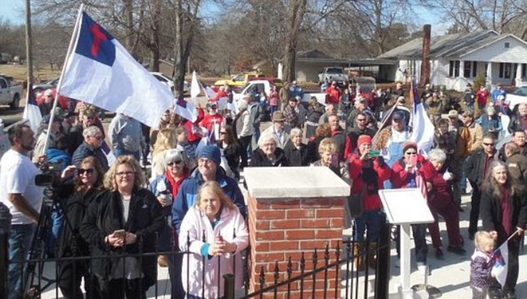 Residents of Rienzi, Miss., rallied Saturday after the town's mayor said he was forced to remove a Christian flag from Veterans Memorial Park, following the threat of a lawsuit by an atheist organization, Freedom From Religion Foundation. More than 100 supporters united at the park, where the group waved Christian flags. FFRF representatives said the flag in question needed to come down to avoid unconstitutionally endorsing religion on public grounds.
