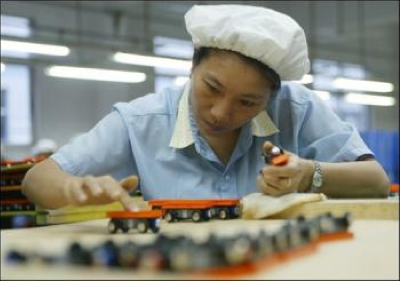 A worker checks a wooden toy in a factory in the southern province of Dongguan (PhotoAFP).jpg