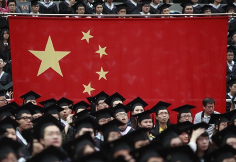 Graduates set next to the Chinese flag during a graduation ceremony at Fudan University in Shanghai June 28, 2013